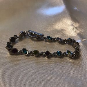 Multi color stones; silver; light.